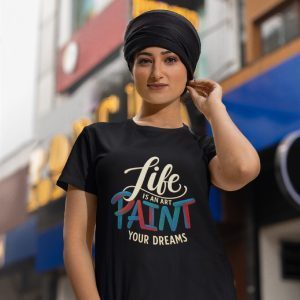Women’s crew neck cotton T-shirt with the quote “Life is an Art, Paint Your Dreams” in colorful typography – Salt & Soil streetwear.
